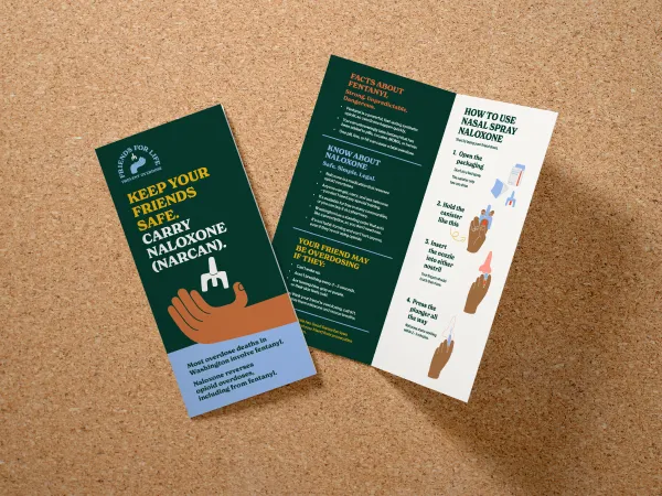 Bifold brochure with dark background and a hand holding naloxone