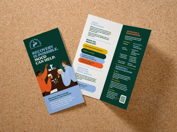 Image of a pamphlet with a dark background and two people at a table holding cups