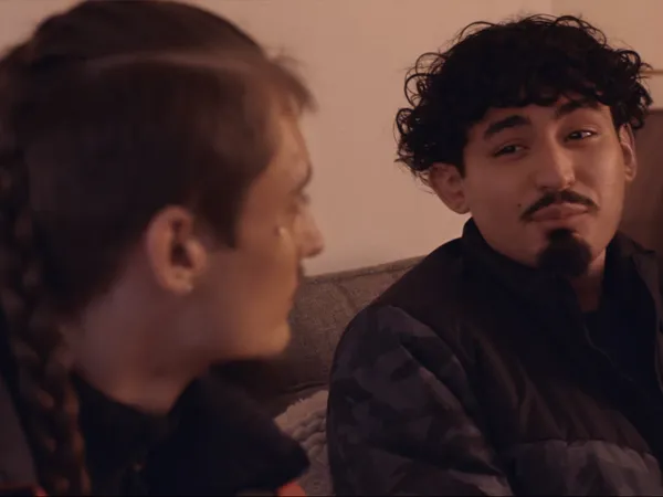 Two young adults having a conversation.